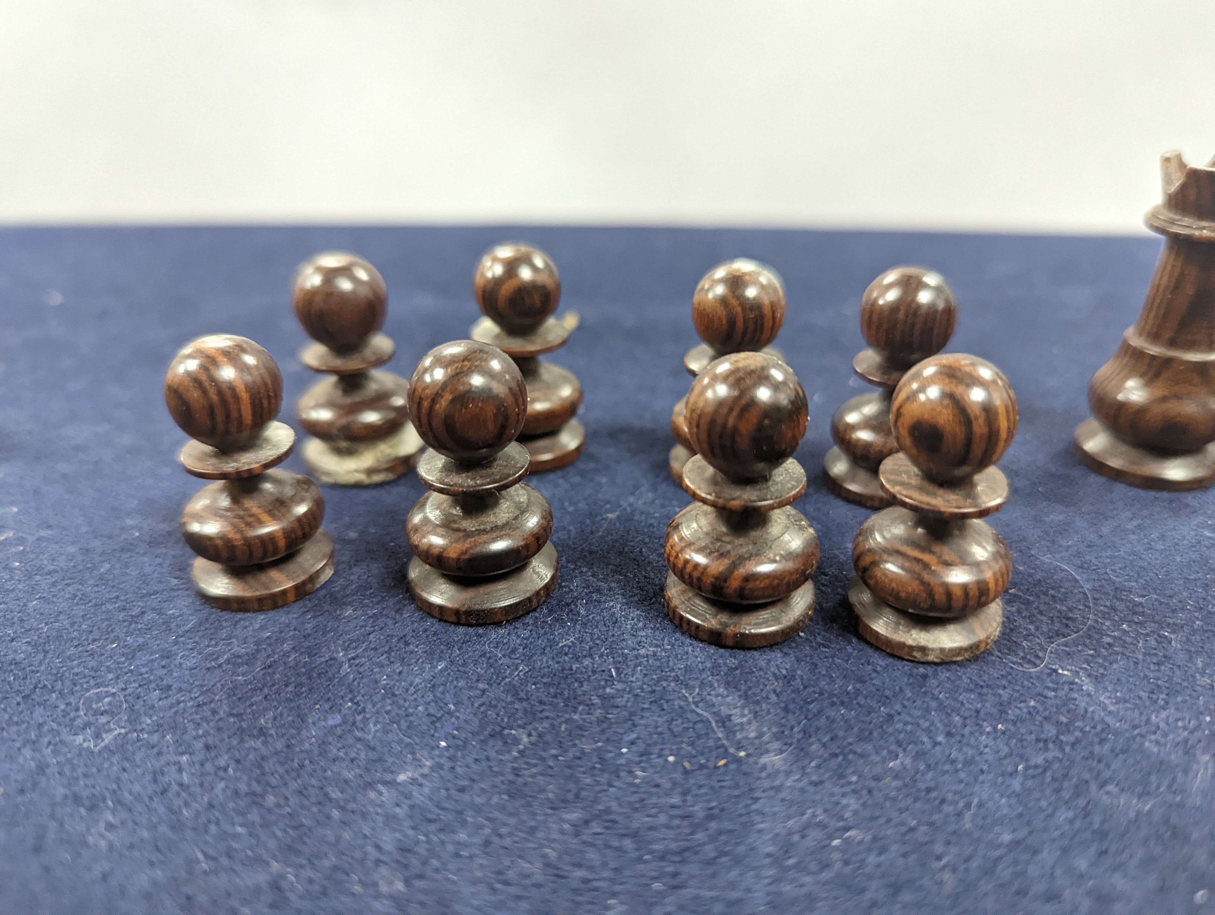 A Victorian brass inset mahogany games box, fitted with solitaire, cribbage, chessmen, draughts etc., 33cm, a turned and stained bone chess set, another games box containing chessmen and draughts